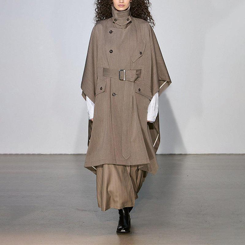 Khaki long trench cape coat with button front, belt at waist, folded cape sleeves.
