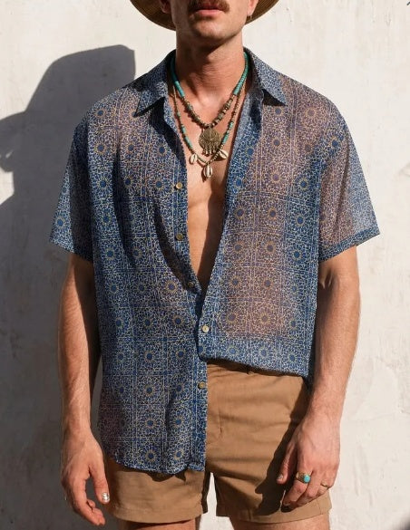 Blue sheer short-sleeve shirt with Moroccan tile motif, open V-neck and spread collar