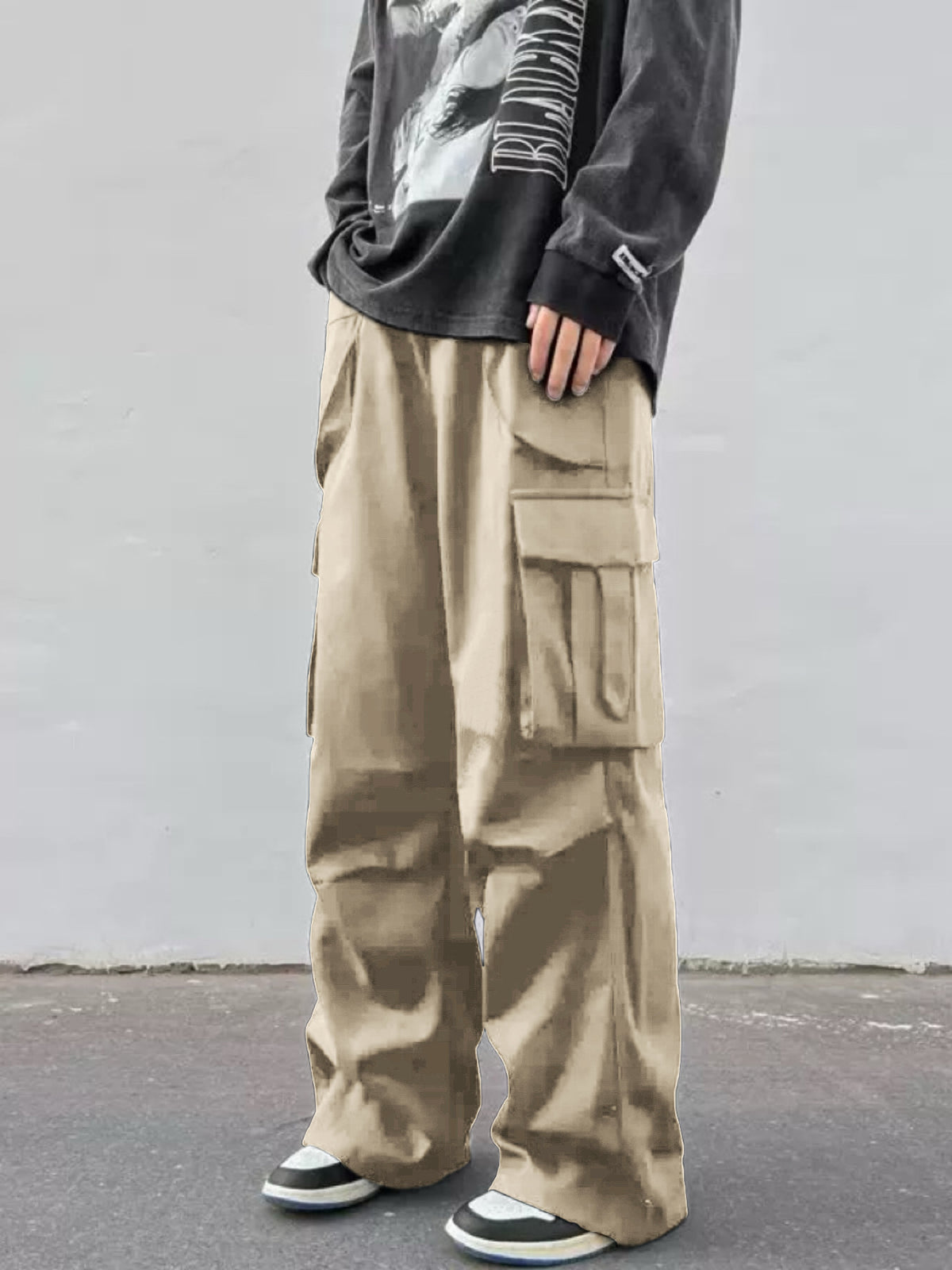 Khaki wide-leg cargo trousers with stacked flap cargo pockets and baggy silhouette