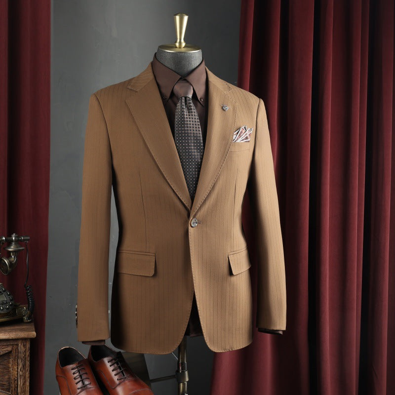 Men's tan suit jacket with matching vest, patterned tie, and pocket square