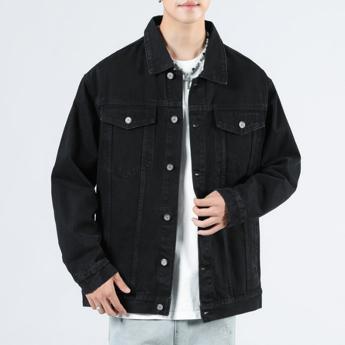 Men's black denim jacket with button front and chest flap pockets, front view.
