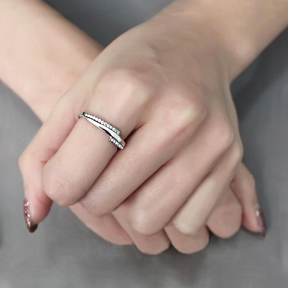 Platinum-plated ring with curved pavé band on a hand