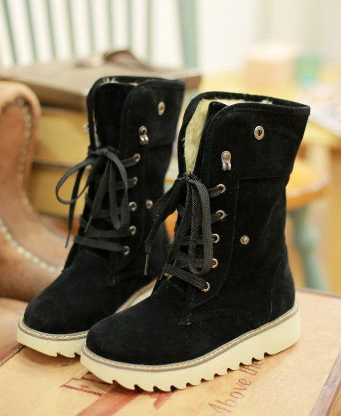 Black faux fur lace-up snow boots with contrast sole and lace-up front