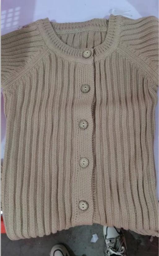 Baby knit jumpsuit romper in beige, long sleeves, ribbed texture, button front.