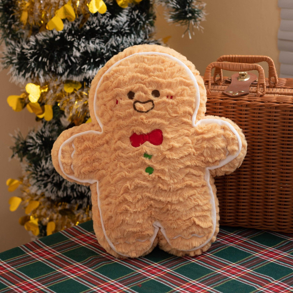 Gingerbread plush pillow doll with smiling face and red bow accents