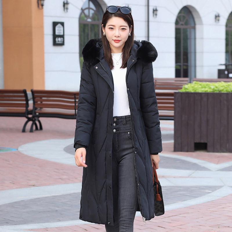 Women’s cotton-padded coat in black with faux fur hood trim and longline silhouette