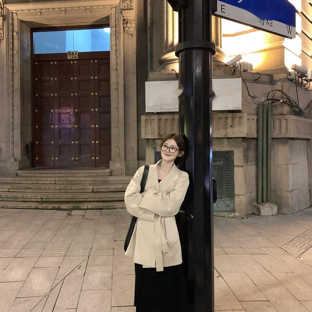 Light apricot mid-length small coat with stand collar and long sleeves, front view