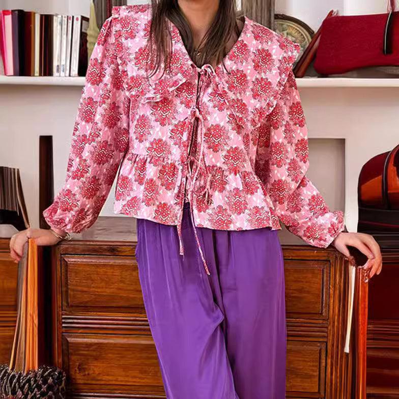 Pink floral blouse with doll collar, long sleeves, and lace-up tie front