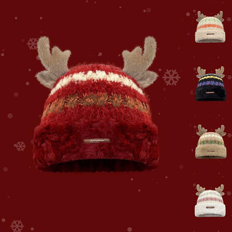 Red knit winter beanie with gray deer antlers and striped band, front brand label.