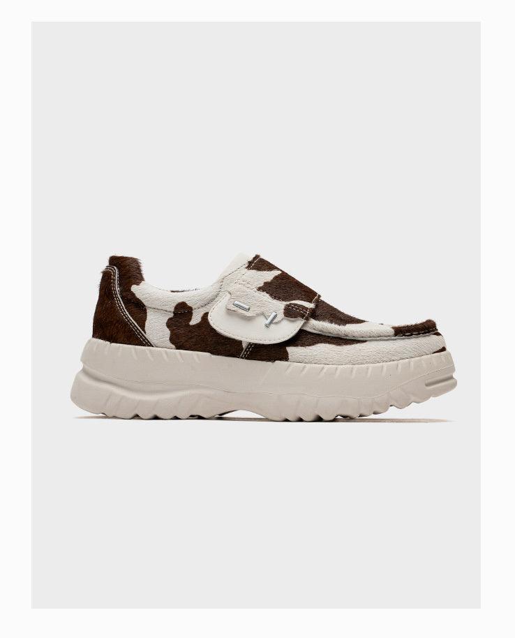 Cow-pattern slip-on sneakers with Velcro strap and thick white platform sole