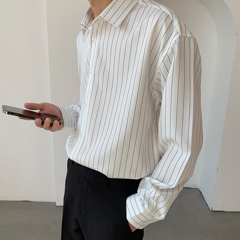 White striped overshirt with button front and pointed collar, long sleeves, loose fit