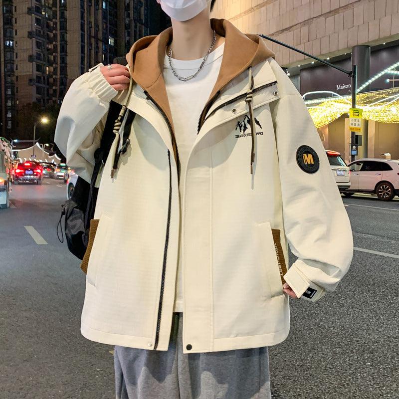 Beige boys hooded zip jacket with brown hood lining, drawstrings, and chest logo patch.