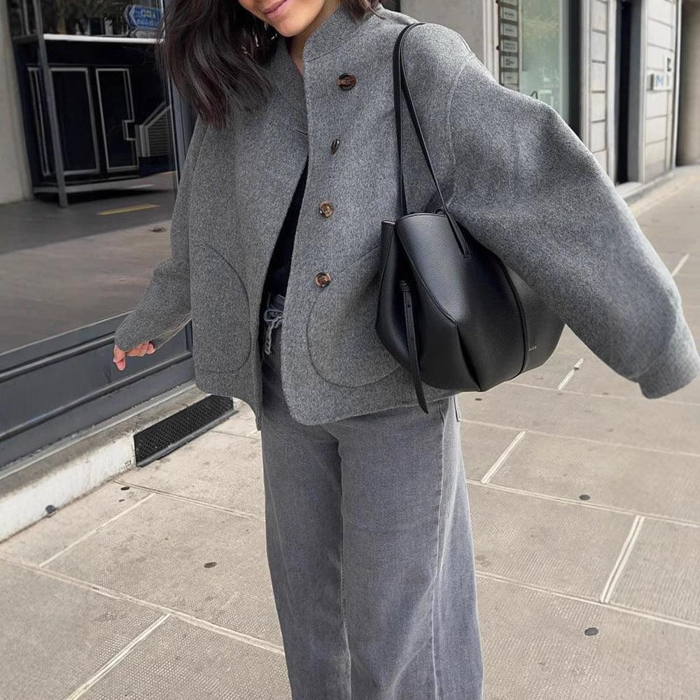 Gray single-breasted jacket with notch lapel, four-button front, and outside seam pockets