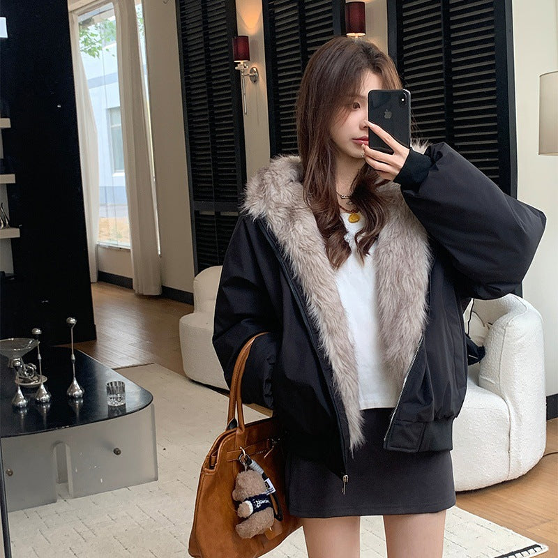 Black loose parka with light faux-fur hood trim and zip-front, long sleeves
