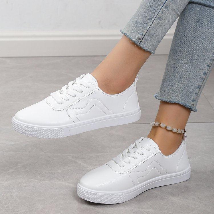 White lace-up flat shoes with round toe and stitched side panels