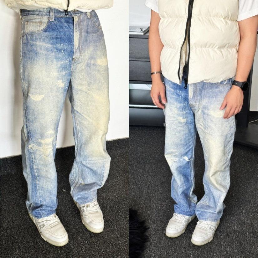 Distressed light-wash denim trousers with faded patches and button-zip fly