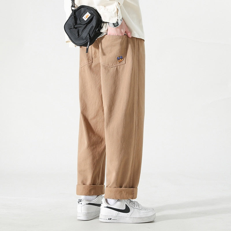 Men's loose cargo pants in tan, straight leg, cuffed hems, side cargo pocket and patch
