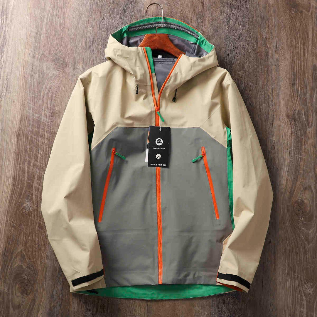 Hard shell jacket with hood, beige top, gray panels, orange zip, green inner trim