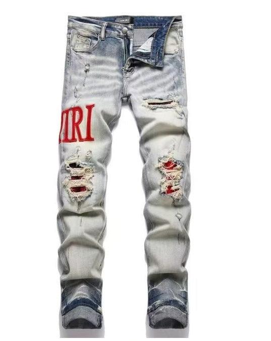 Light blue slim jeans with red “IRI” text print and distressed patchwork