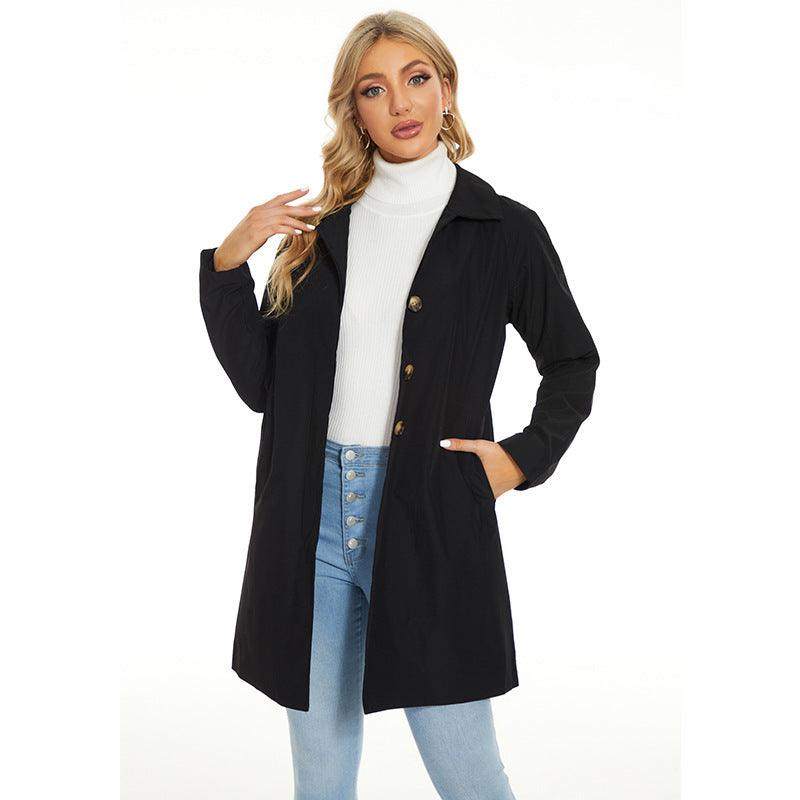 Women’s trench coat in black with button front and notched lapel collar