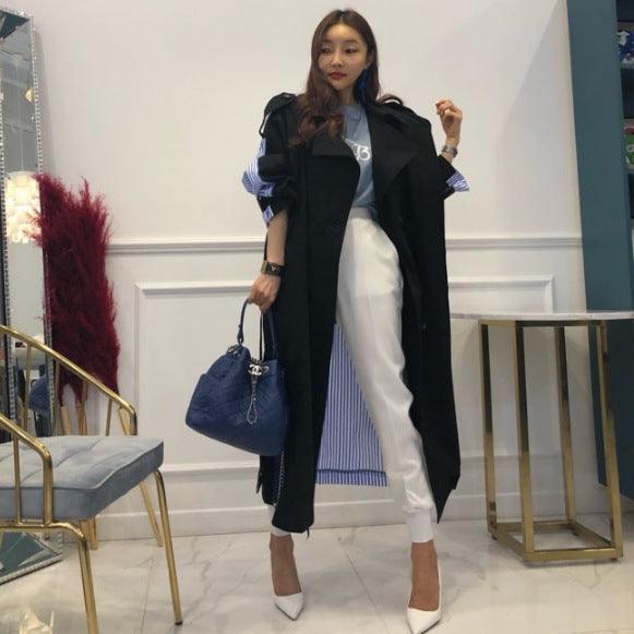 Black lapel trench coat with tie belt, long sleeves and long length