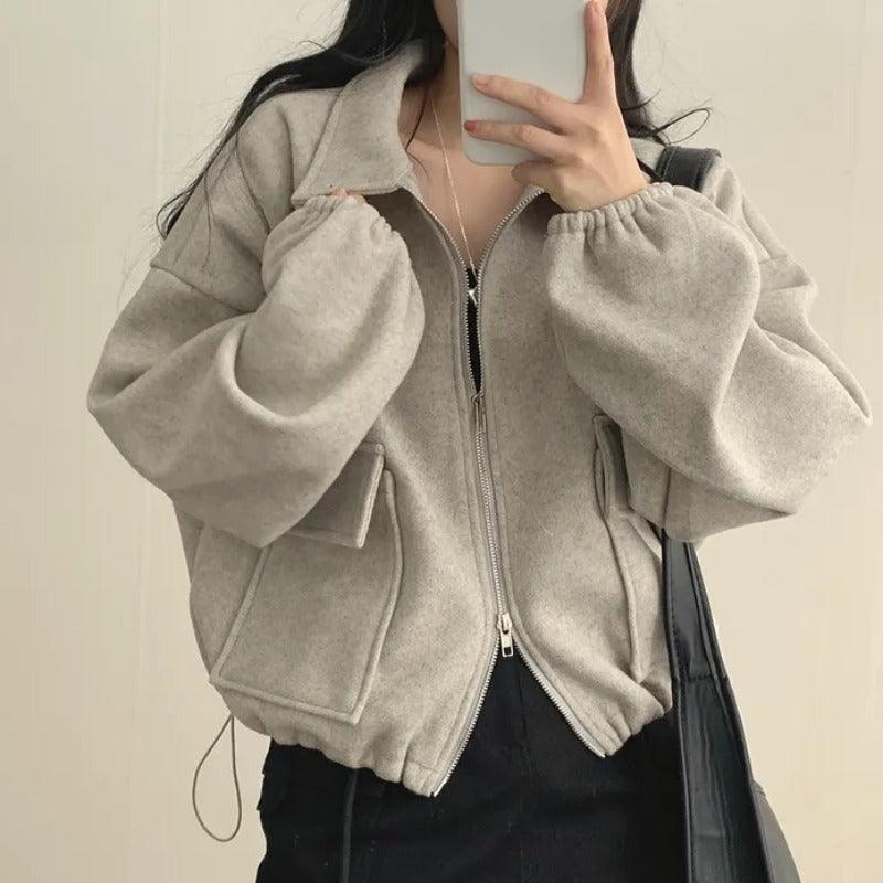 Light gray short coat with zip front, lapel collar, drawstring hem, two front pockets