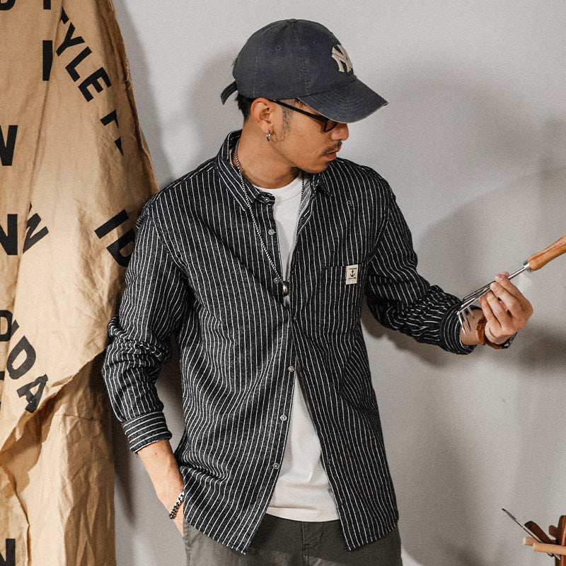 Black vertical-striped button-up shirt with chest logo patch, long sleeves