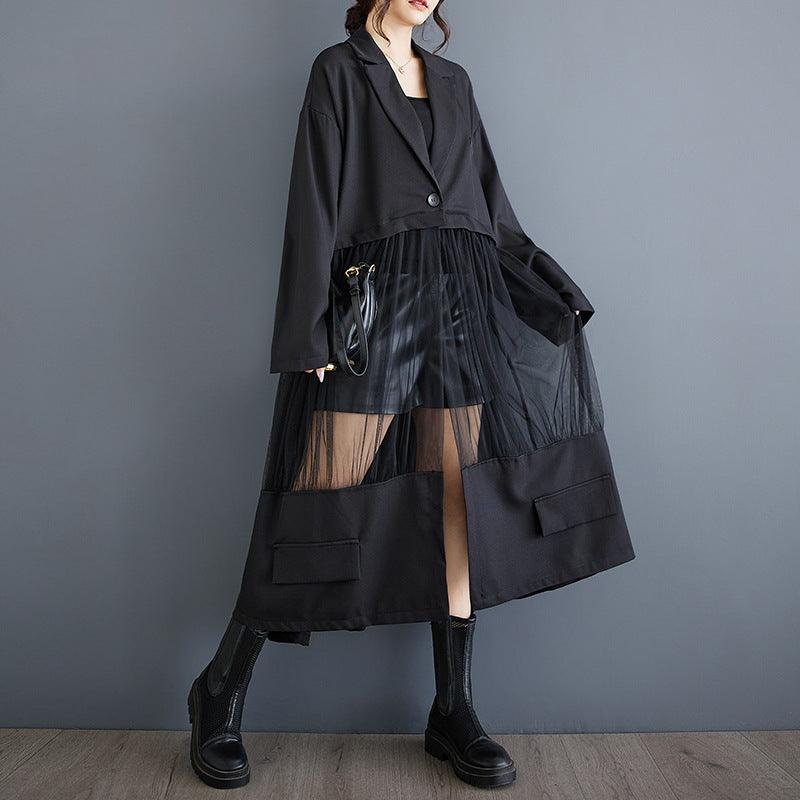 Long black patchwork mesh skirt with sheer panels and two front flap pockets