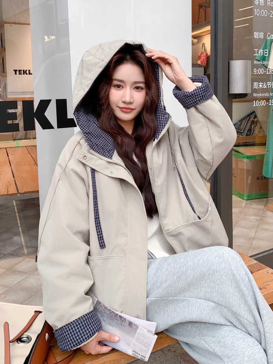 Women's beige hooded short coat with patchwork collar and zip front, hood up.