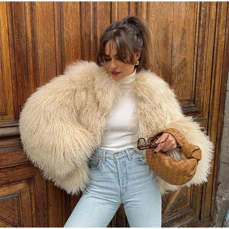 Beige short fur coat with long sleeves and fluffy shaggy texture