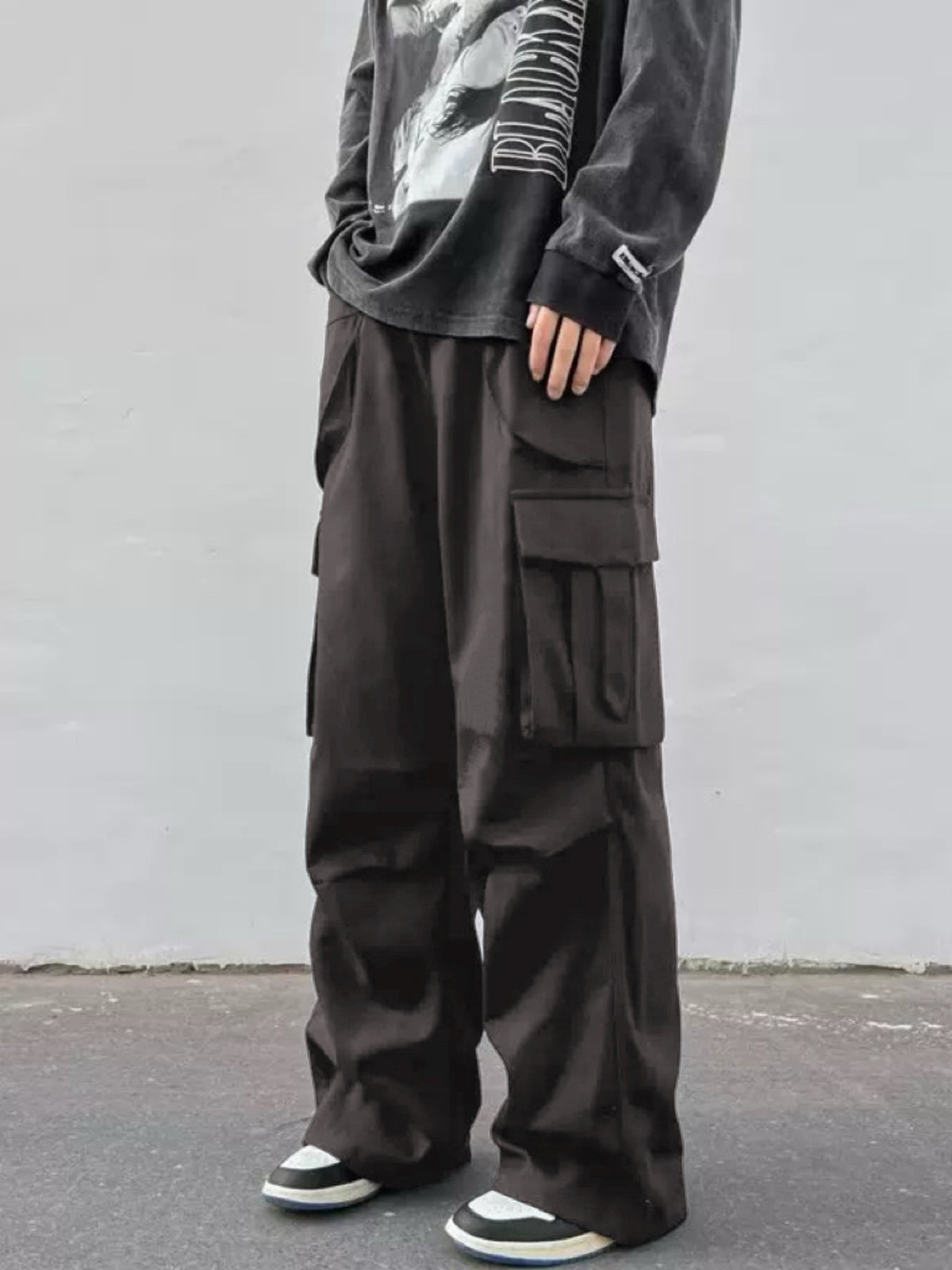 Dark cargo wide-leg trousers with flap side pockets and straight, loose legs