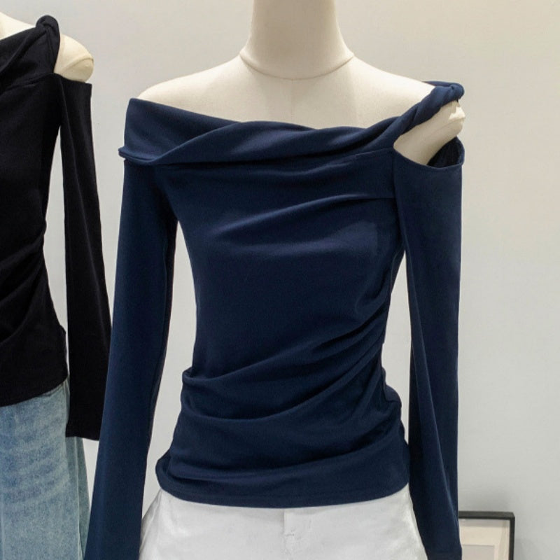 Navy off-shoulder long-sleeve top with draped asymmetrical neckline and ruched fit