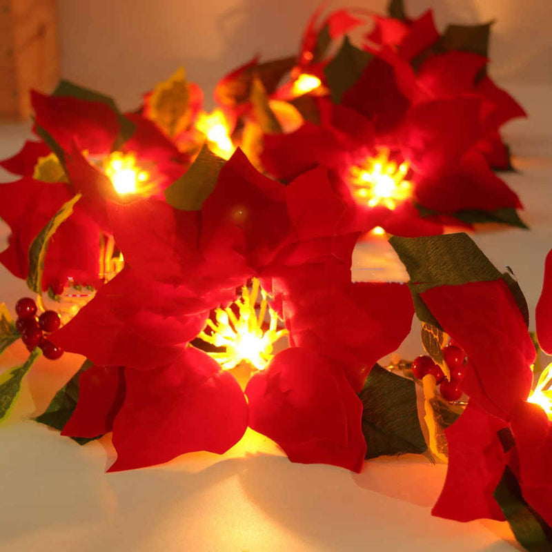 Decoración de escalera mecánica con marco de puerta y luces de cadena de flores rojas