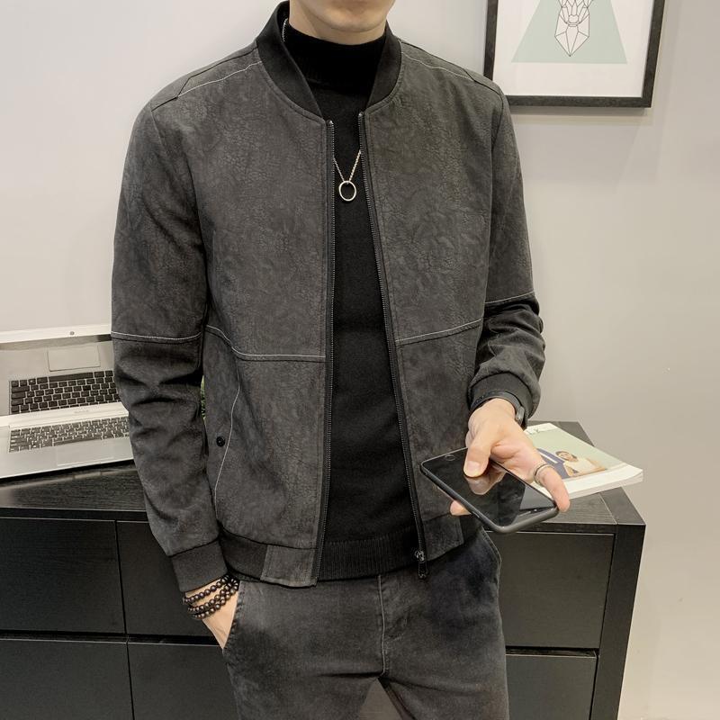 Gray zip-up jacket with stand collar, front pockets, worn over black knit top
