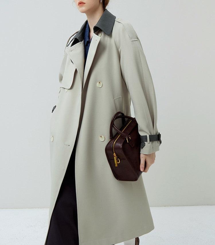 Women's long windbreaker coat with stand collar, button front, and flap pockets