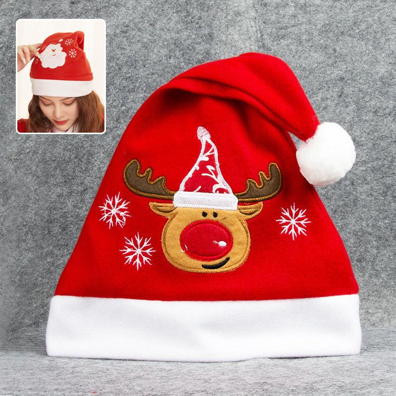 Red Christmas Santa hat with white trim, pom-pom, and embroidered reindeer face