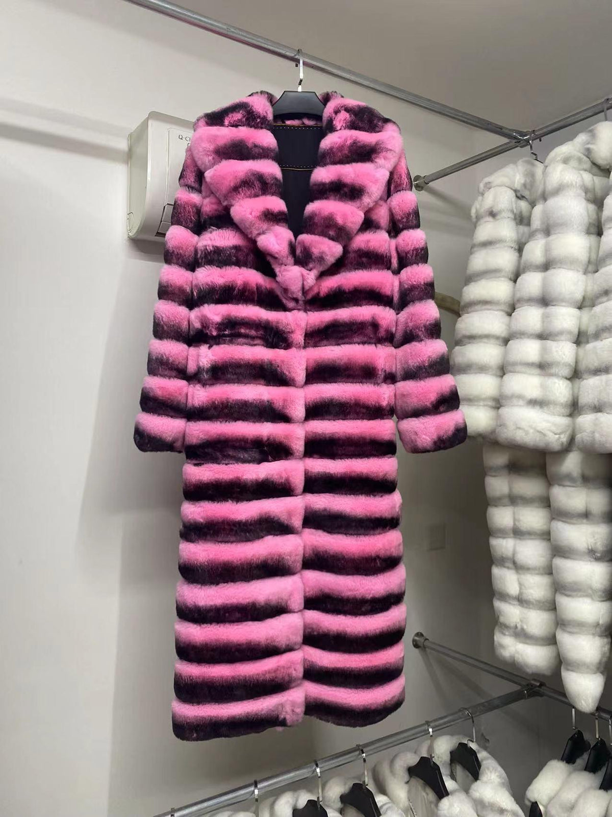 Pink and black faux fur jacket with standing collar, horizontal stripe design