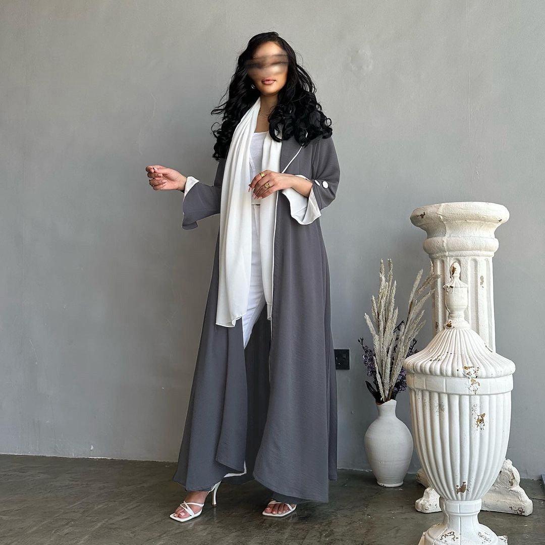 Long cardigan dress in dark grey with open front, lapels, long sleeves, and side pockets.