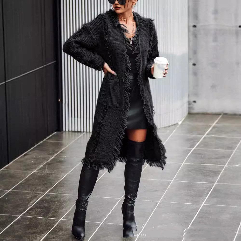 Black lapel tassel long knitted coat with open front and fringe details.