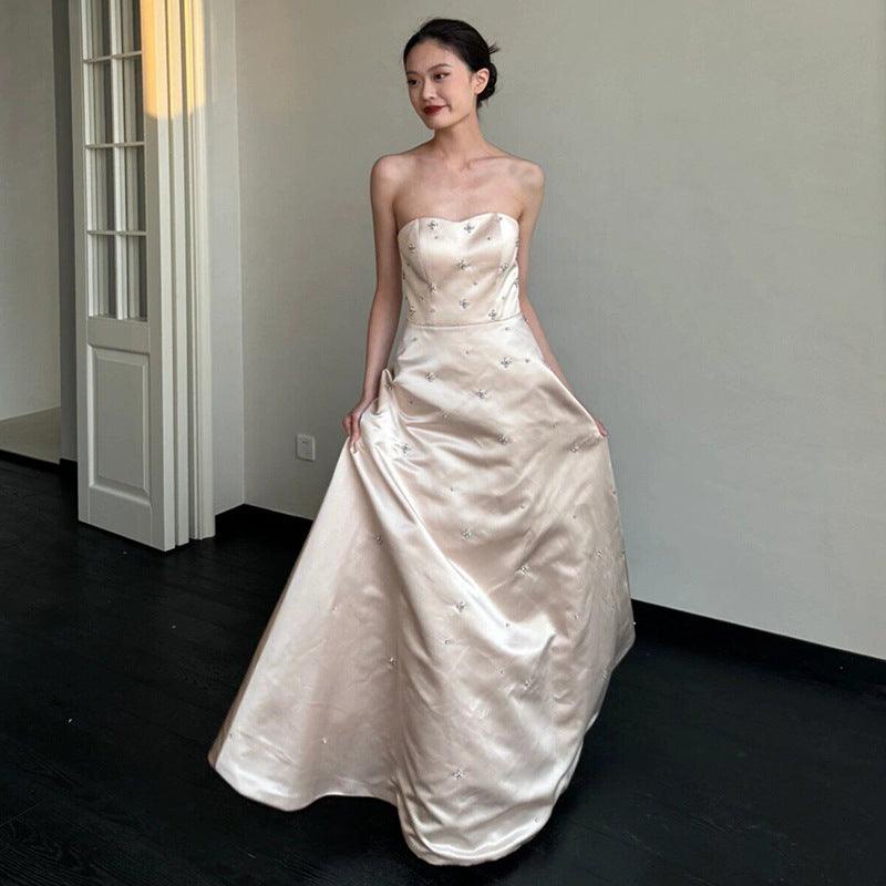 Champagne satin strapless wedding dress with sparkly star details and voluminous floor-length skirt