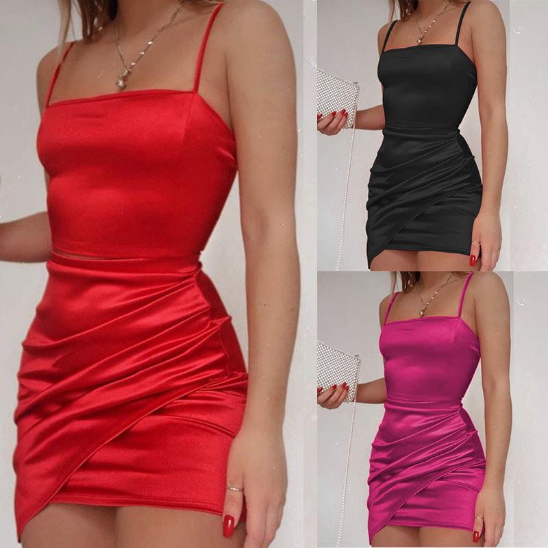 Red pleated solid-color sling dress with ruched waist and short fitted skirt.