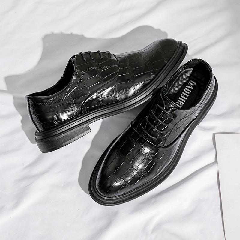 Black leather lace-up dress shoes with crocodile-style texture and metal-toned eyelets