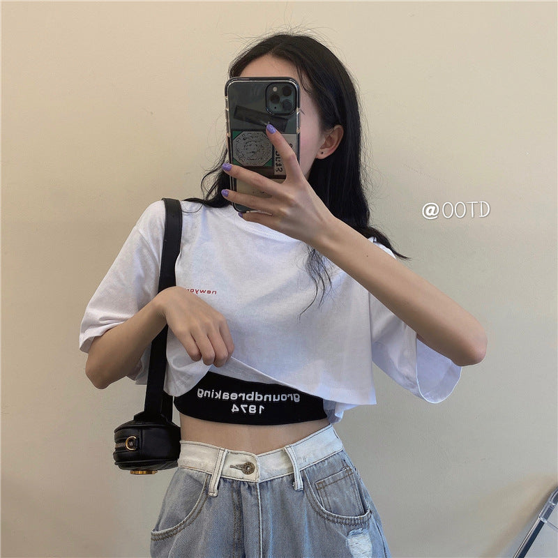 Black sleeveless crop top with “groundbreaking 1974” print, scoop neck