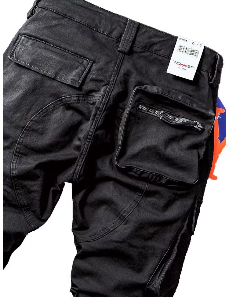 Men’s black cargo overalls with front patch pockets and a zippered utility pouch