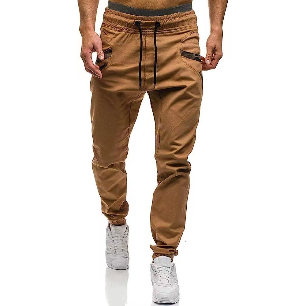 Khaki cargo pants with drawstring waistband, straight legs, side cargo pockets, cuffed ankles.