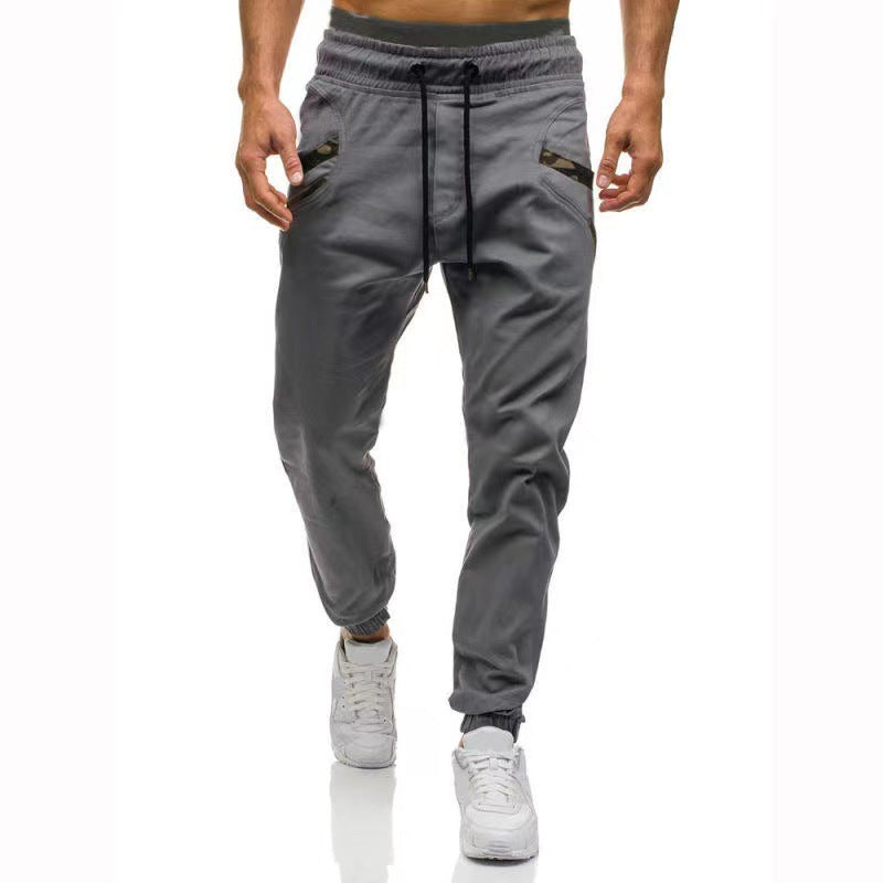 Dark gray cargo pants with drawstring waistband, straight legs, side cargo pockets, ankle cuffs.
