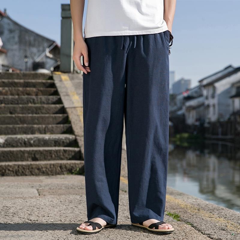 Loose cotton-linen trousers in navy blue with straight wide legs and drawstring waist