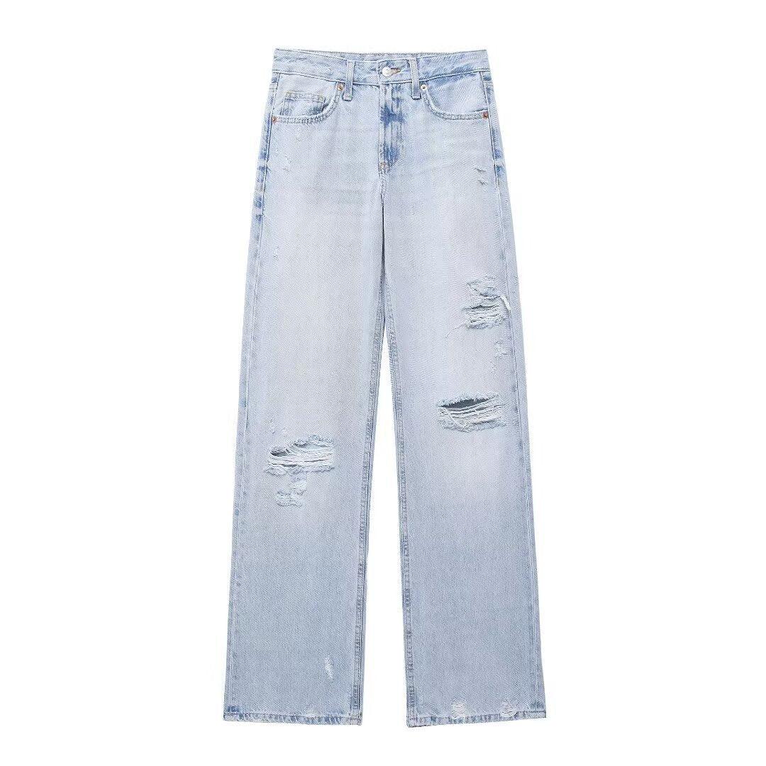Light blue mid-rise wide-leg jeans with rips and decorative distressed patches