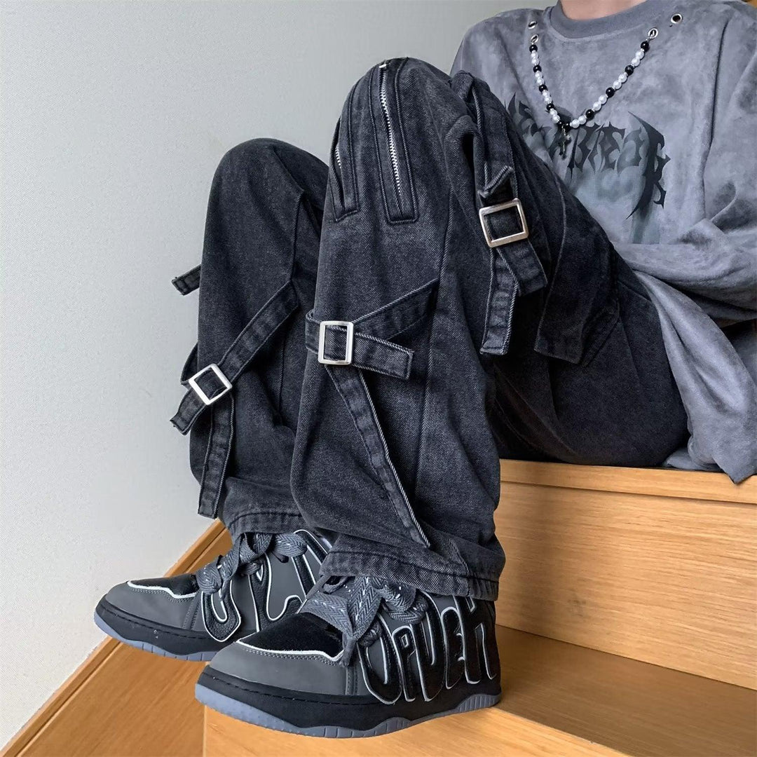 Men's black denim jeans with cargo pockets and adjustable buckled strap details