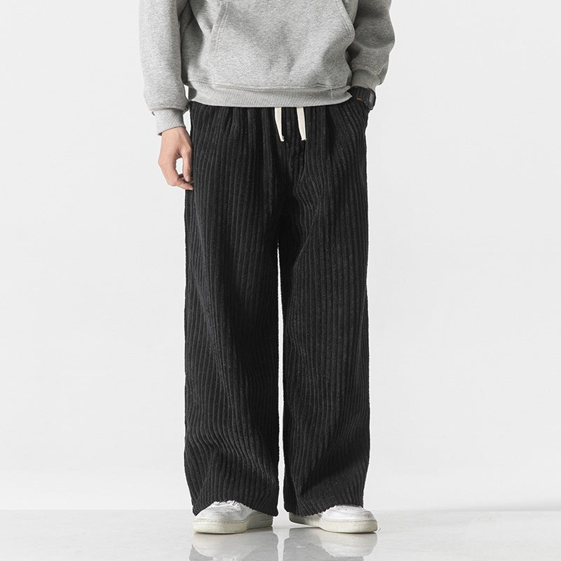Black corduroy wide-leg pants with elastic waist and drawstring, relaxed drape